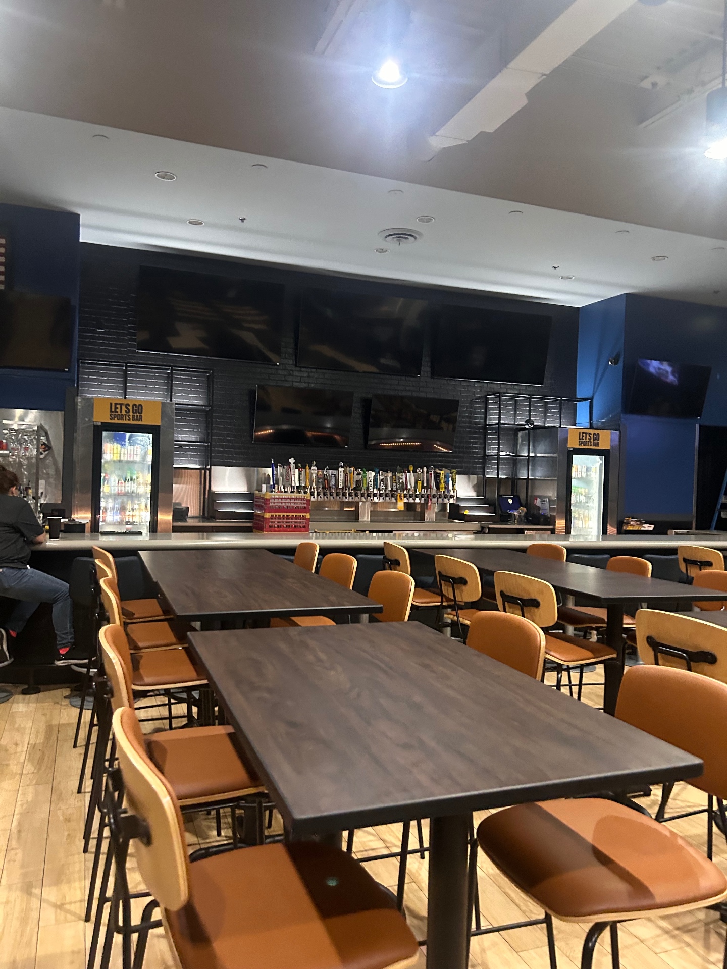 Sports bar after — black panel wall and new seating