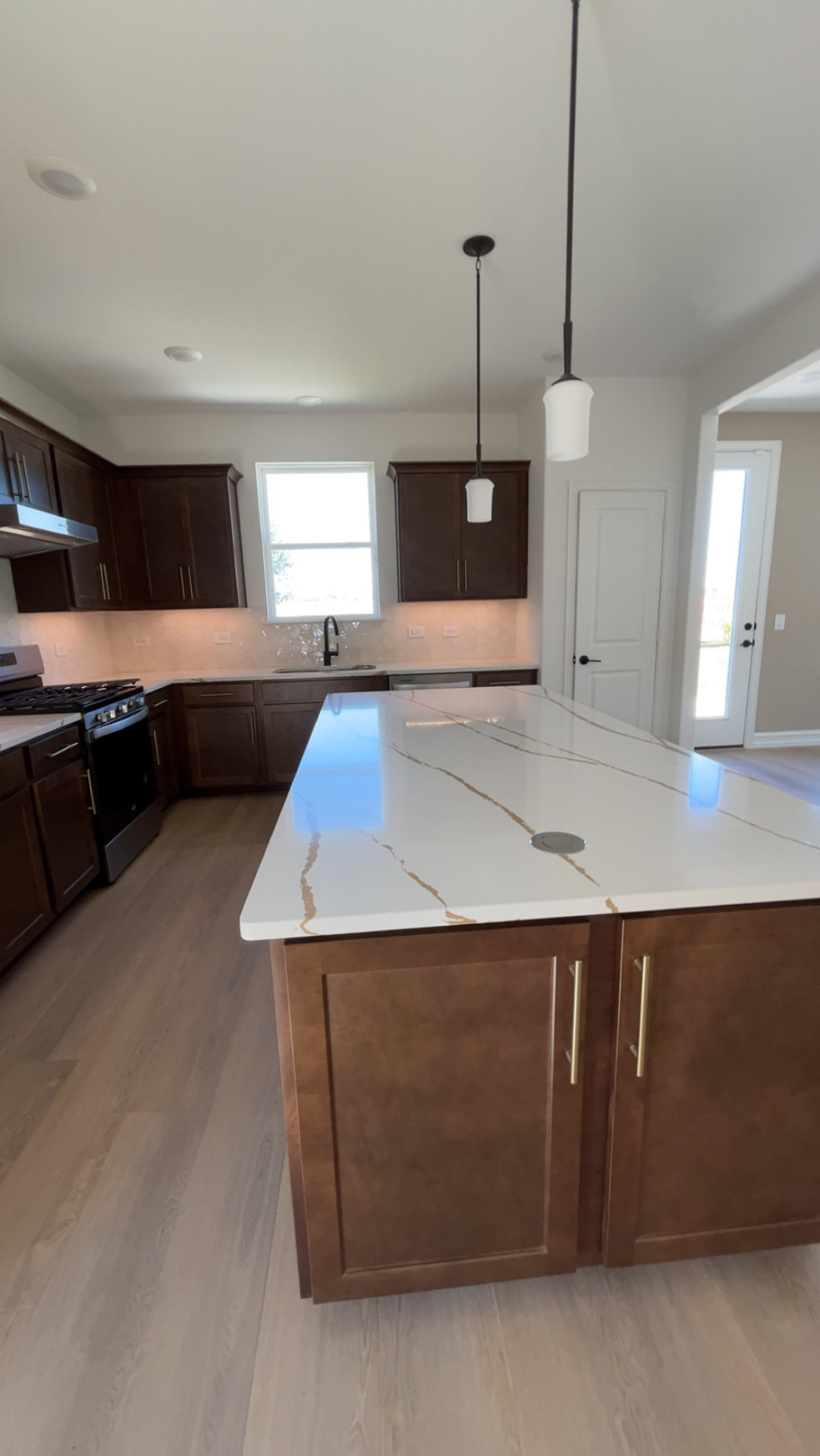 Kitchen remodel with quartz island and dark wood cabinetry